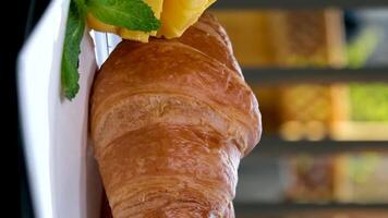 Caramel Croissant. Fresh croissant with caramel toppings isolated on white background. Macro image video