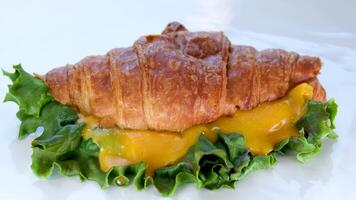 Sandwich with cheese on croissant bun. Tasty croissant sandwich. video