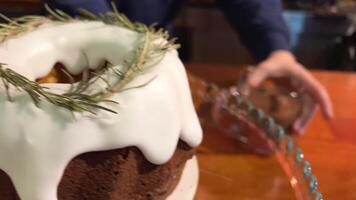 buy in a cafe Hot chocolate and Christmas cake with needles, tree branches, sugar sprinkle, the waiter serves a glass cup on the counter, delicious, fragrant and festive Christmas New Year Easter video