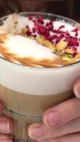 A woman puts down a cup and picks up a cup of coffee on a romantically decorated table.Valentine's video