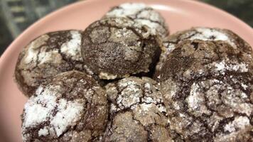 Chocolate chip cookies with cocoa and powdered sugar on a plate on a white background. video