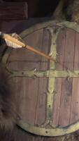 decoration from the ancient period bear skin on the wall Shield and Arrow stuck with a feather real attribute of war on the shield cross wooden restaurant on the wall interior video