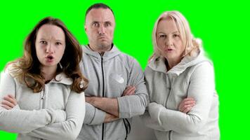 three dissatisfied indignant people a man two women a young teenage girl middle-aged people look evilly into the frame and dance an angry look video