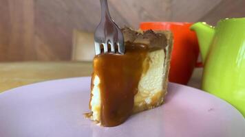 Eating caramel cheesecake. Taking bite of caramel cheesecake with fork video