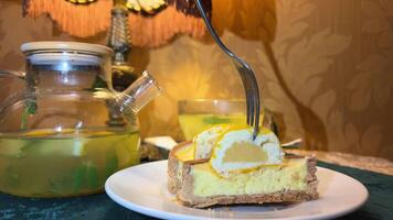vitamin citrus tea and lemon cake tart cheesecake with lemon delicious food freshness treatment for colds craft desserts and drinks hot cold season mint leaves In a dark cafe restaurant video