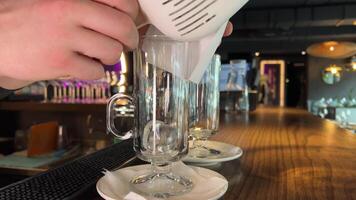 throw ice into a glass barwoman pouring large ice cubes into a glass for a drink video