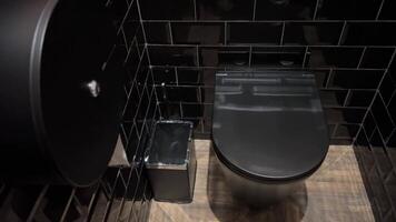 black toilet bowl in gray stylish bathroom video
