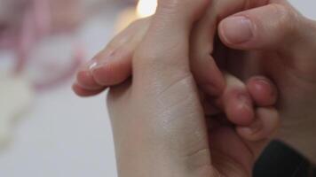 Massage of hands close up on candle on background video