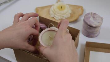 Putting craft candles in a paper box gift decor is beautiful art of making with your own hands forming a beautiful gift. video