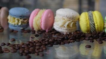 Group of four whole pink and yellow sweet meringue isolated on black glass video