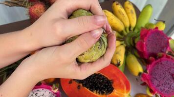 Hard unripe fruit Noah and trying to break it with your hands needs to finish ripening Assorted fresh ripe fruits and vegetables. Food concept background. Top view. Copy space. video