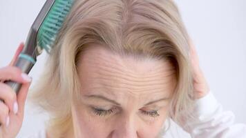 Closeup on a young woman combing her hair video