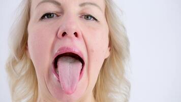 Portrait of Caucasian woman shoving tongue gymnastic exercise. Training of diction. Isolated on white background. video