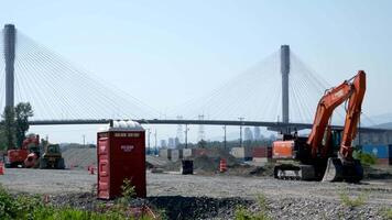 port mann bridge canada over the Fraser River in BC interesting unusual footage of bridge from bottom up repair work construction cranes near the bridge portable toilet trucks under the bridge video