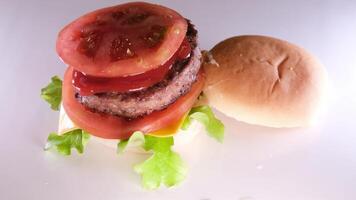 Appetizing fresh bun with sesame seeds to fall on the seductive juicy big burger video