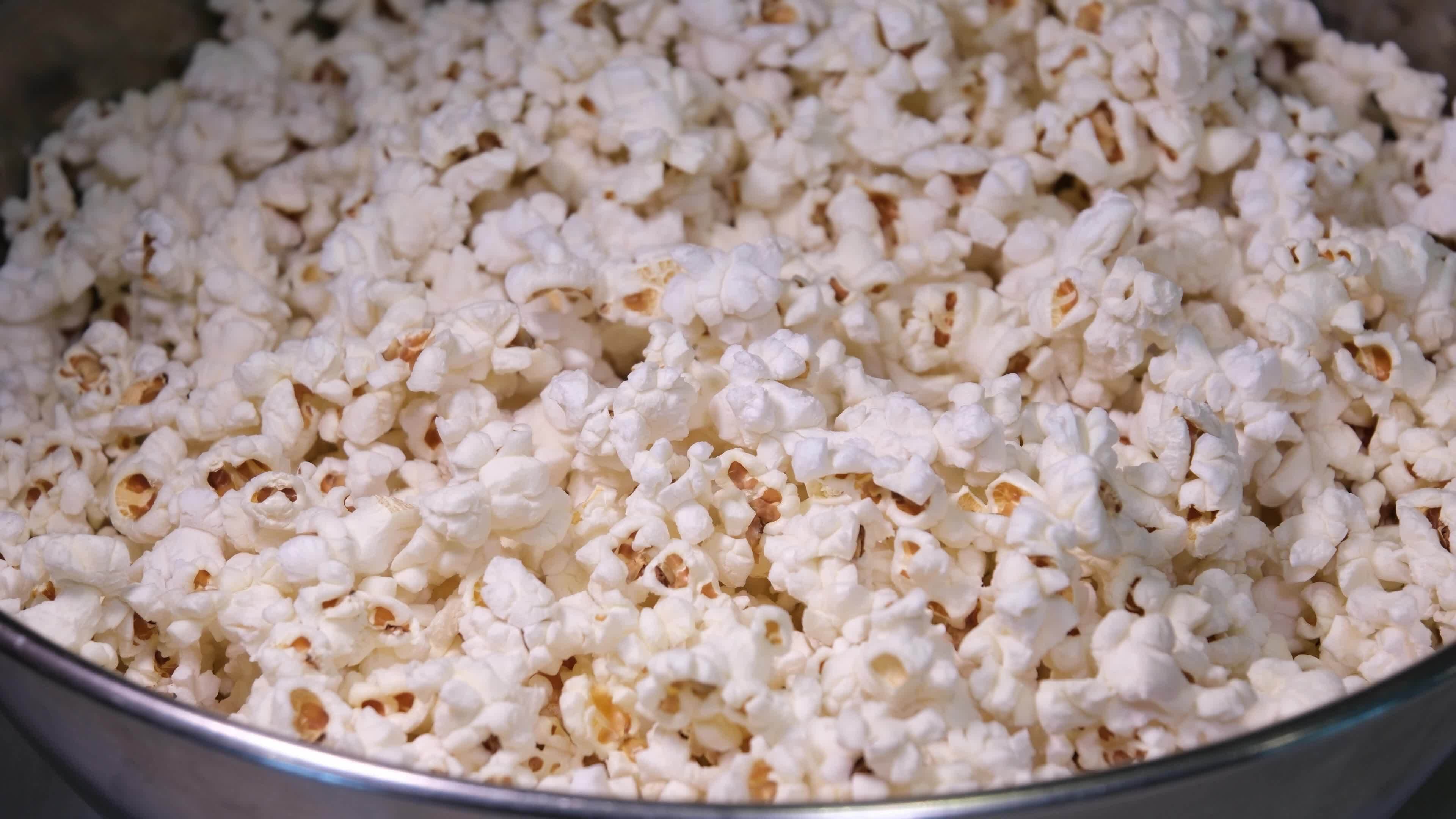 Cooking Popcorn popping on heated fry pan. Slow Motion. Making Popcorn