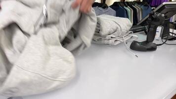 lululemon comprando ropa de deporte gris chandal en Tienda a el revisa niña vendedor pone nuevo ropa en un bolso joven mujer adolescente compra un lote de pantalones alegría contento teniendo un bueno hora y compras video