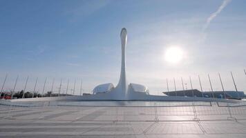 Central square in Olympic Park in Sochi. Action. Summer landscape with an unusual sculpture on blue sky background with shining sun. video