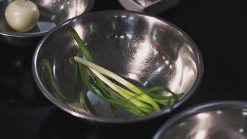 Green onions are in a metal container. ART. Onion in an iron plate. Products are ready to go video