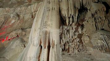 Inside lighted cave. Action. Amazing nature of stone caves inside mountains. Excursions to cave museums. Natural stone pillars in cave video