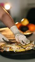 Homemade food close-up. On the table, women's hands wrap a tortilla filled with ingredients. Asian dishes in the home kitchen. Lavash in an egg and chicken with Beijing cabbage and onion in a sauce video