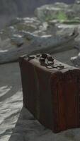 A piece of luggage sitting on top of a sandy beach video