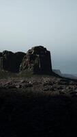 A large rock formation in the middle of a desert video