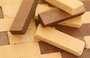 Stacked delicious chocolate wafers in large amount. Two different flavours of classic waffles photo