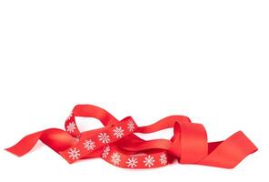 Christmas red ribbon with white snowflakes isolated. photo