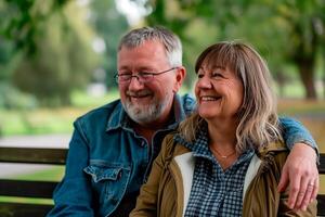 Happy elderly couple having a good time at the park. photo