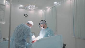 Process of surgery in a hospital operating theater. Action. Surgeons working on patient in operating room, concept of disease. video