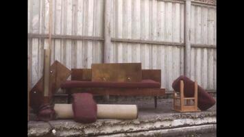 Garbage disposal area with retro furniture. Stock footage. Throwing away old fashioned couch, chair, and wooden drawers. video