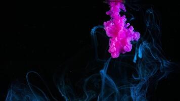Splash of paint in glass of water. Concept. Brush with paint is rinsed in glass of water. Beautiful splash of bright pink paint in water on white background video
