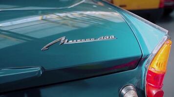 Classic retro or vintage car details. . Close up of a trunk and parking lights of a beautiful dark turquoise old fashioned car. video