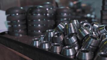 Close up of metal parts of a pipe fitting plant. . Metal new shiny bushings at the metallurgical factory. video