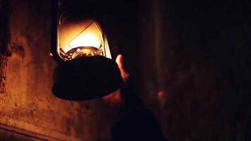 Hand taking old fashioned hanging street lamp outdoors. . Dark scary street with a retro street lamp at night. video