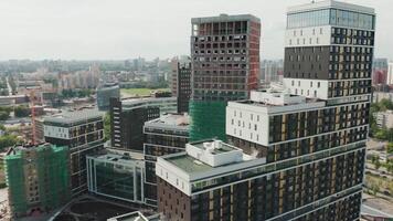Aerial view of a newly built luxury residential complex and the construction site in progress. . Panoramic view of a big city on a summer sunny day. video