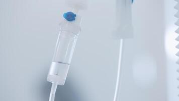 Close-up of IV tube. Action. Dropper with drug slowly dripping down tube. IV tubes for sick patient after surgery video