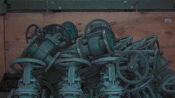 Metallurgical production of pipe fittings plant. . New valves in a stack inside the workshop of a factory, heavy industry concept. video
