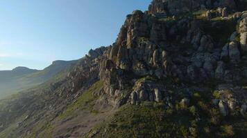 Beautiful flight on rocky slopes of mountains. Shot. Mountain slopes with variety of rocky formations surprise with their beauty. Mountain scenery and rocky slopes are mesmerizing on sunny day video