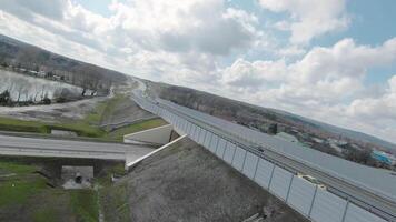 Flying drone on country road with tunnel. Shot. Beautiful panorama with country highway and drone following car. Top view with drone following car on motorway video