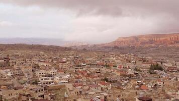 Top view of old town in canyon. Action. Beautiful panorama of stone city on background of canyon and cloudy sky. Southern city landscape in stone canyon valley video