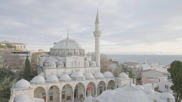 Beautiful white mosque on background of cloudy sky. Action. Grand Mosque with great history attracts tourists from all over world. Istanbul Mosques video