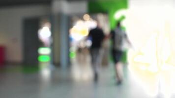 Blurred background of people in a shopping center. HDR. Defocused view in a shopping mall with walking men and women. video