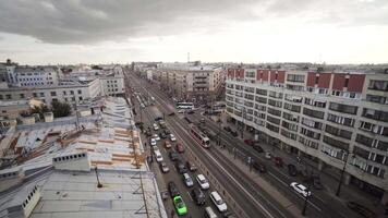 Top view of busy street of gray city. Action. Avenue with car traffic in city on cloudy day. City street with roadway on gray day video