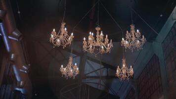 Elegant luxury chandelier with crystals and artificial candles on the ceiling inside a building. . Bottom view of a golden chandelier with rhinestones, theatre interior details. video