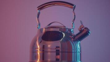 Close up of a steel polished kettle with whistle for the gas stove. Action. Metal teapot isolated against the wall under pink light. video