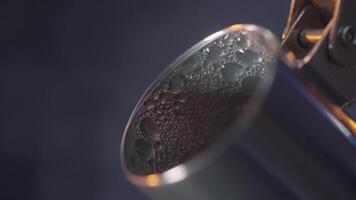 Close up of hot kettle and the steam coming from the spout on blue wall background. Action. Drops of water on a metal teapot spout. video