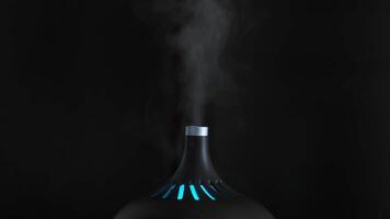 Close-up of humidifier. Action. Black designer humidifier with steam jet on dark background. Stylish humidifier glows and refreshes air in room video