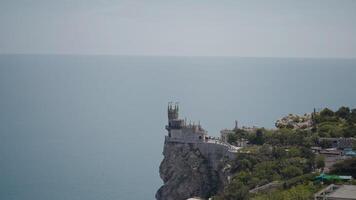 Castle on edge of rocky cliff by sea. Action. Beautiful castle on edge of sea cliff. Fabulous landscape with castle on edge of sea cliff video